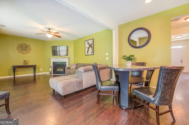 living room with ceiling fan and dark hardwood / wood-style floors