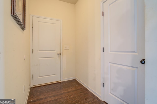 corridor with dark hardwood / wood-style floors