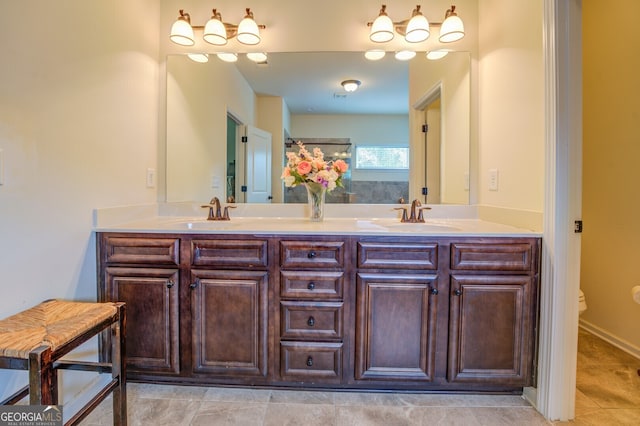 bathroom featuring double vanity, tile patterned flooring, and toilet