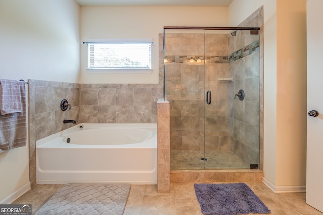 bathroom featuring plus walk in shower and tile patterned floors