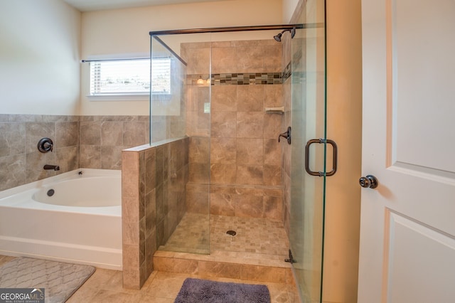 bathroom with independent shower and bath and tile patterned floors