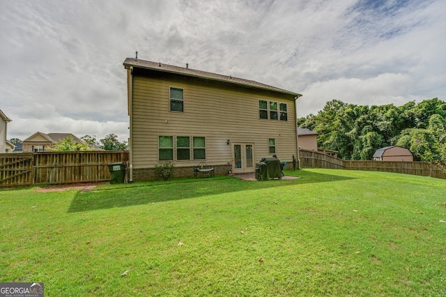 rear view of property featuring a yard and a patio area