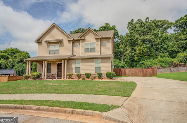 craftsman house with a front yard and covered porch