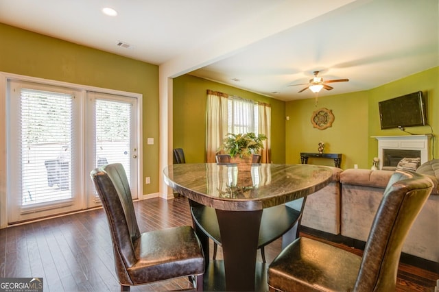445 Brickstone Way, Covington, GA 30016 - dining room with dark wood-style floors, ceiling fan, a glass covered fireplace, and recessed lighting