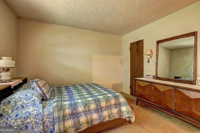 carpeted bedroom featuring a textured ceiling