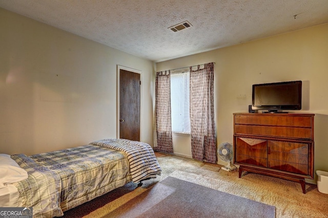 carpeted bedroom featuring a textured ceiling