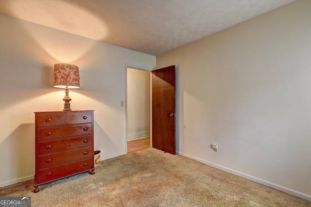 carpeted bedroom featuring a textured ceiling