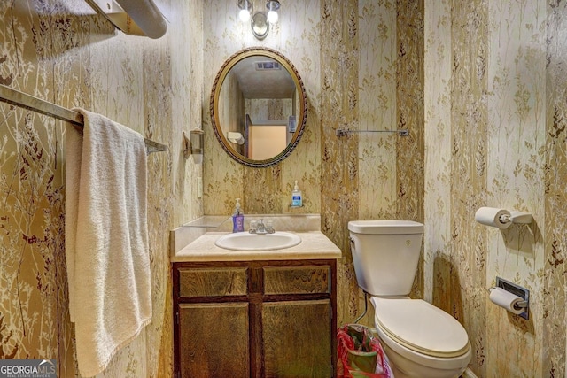 bathroom featuring vanity and toilet