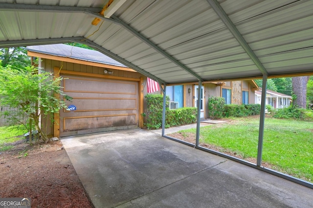 garage with a carport and a lawn