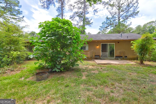 back of property featuring a yard and a patio area