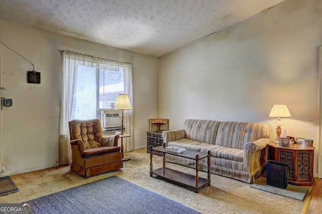 living room featuring cooling unit and a textured ceiling