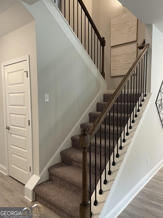 stairs featuring wood-type flooring