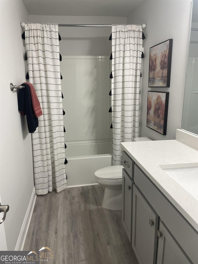 full bathroom featuring vanity, toilet, shower / tub combo, and hardwood / wood-style floors