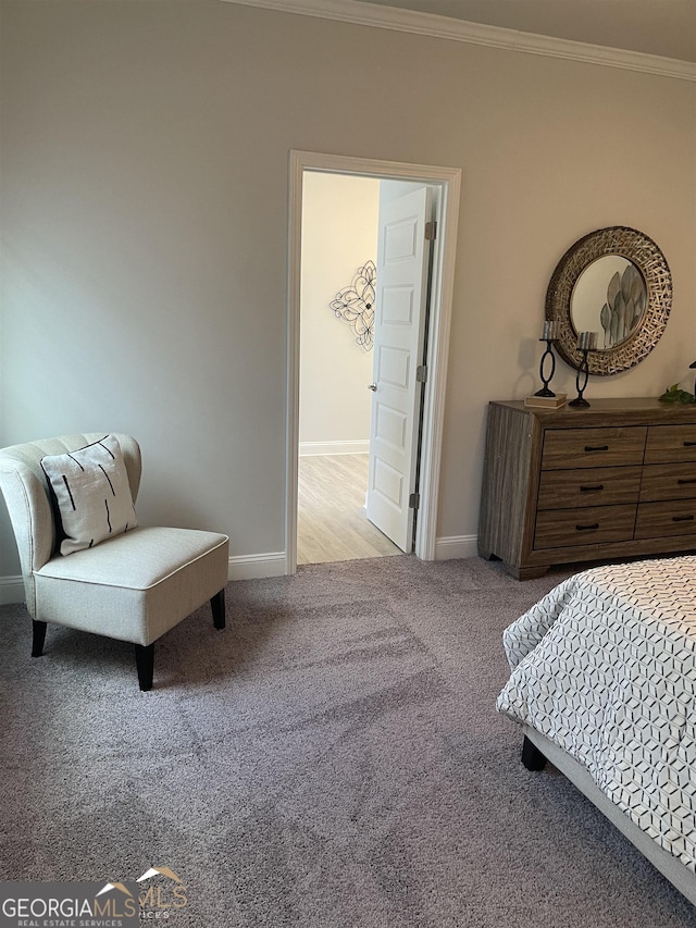 bedroom featuring ornamental molding and light carpet