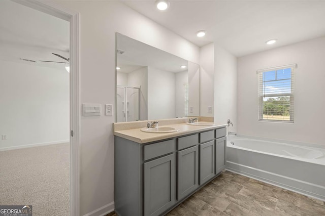 bathroom featuring vanity and shower with separate bathtub