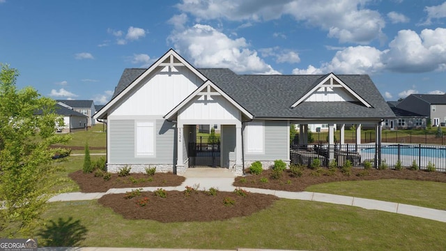 exterior space with a fenced in pool and a front lawn