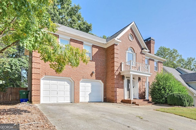 view of front of home featuring a balcony and a garage