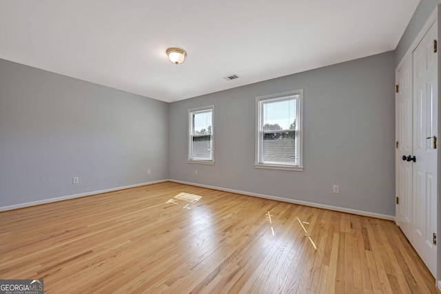 unfurnished room with light hardwood / wood-style flooring