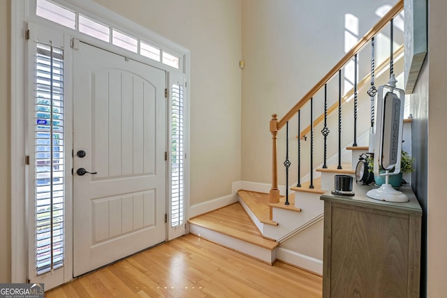 foyer featuring light hardwood / wood-style flooring and a healthy amount of sunlight