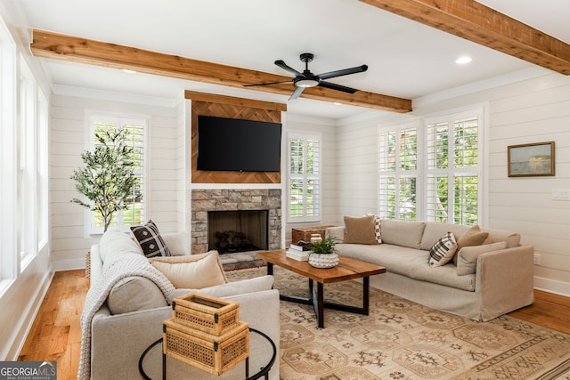 living room with ceiling fan, light wood-type flooring, and plenty of natural light