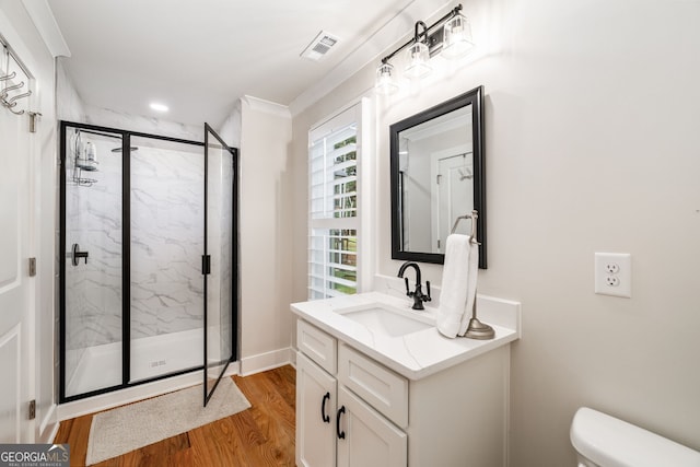 bathroom featuring walk in shower, hardwood / wood-style flooring, vanity, and plenty of natural light