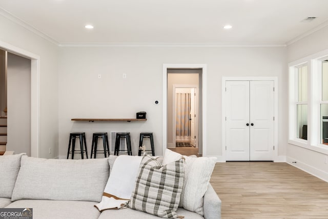 living room featuring light hardwood / wood-style flooring and ornamental molding