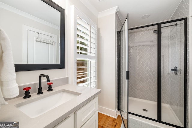 bathroom with vanity, a healthy amount of sunlight, crown molding, and an enclosed shower