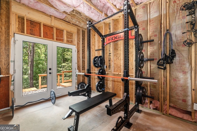 exercise area featuring french doors and concrete floors