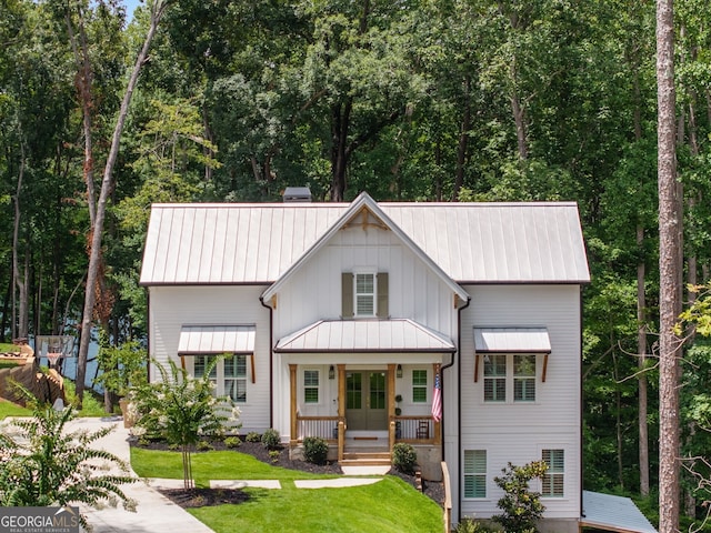 view of front of home with a porch and a front lawn