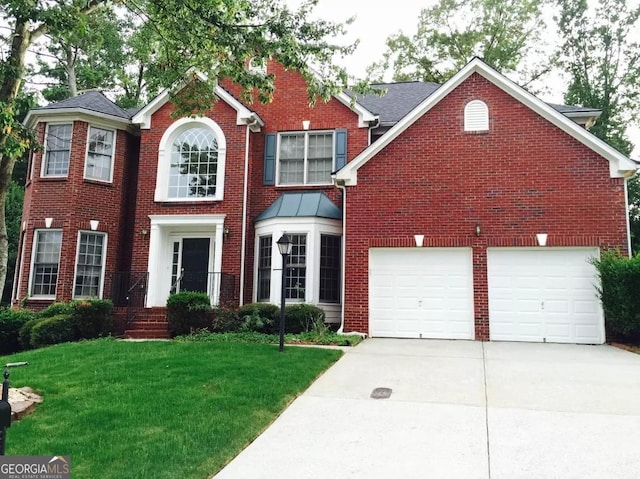 view of front of home with a garage and a front lawn