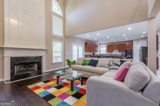 living room featuring a premium fireplace and hardwood / wood-style floors