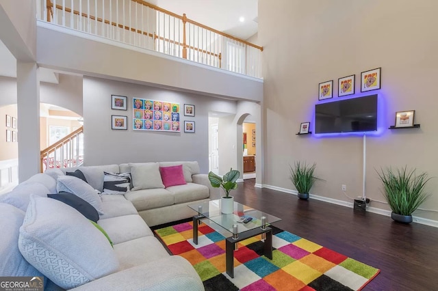 living room with hardwood / wood-style flooring and a high ceiling