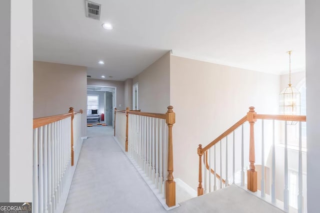 hallway featuring light carpet