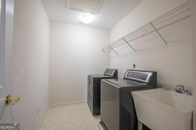 clothes washing area with light tile patterned flooring, sink, and independent washer and dryer