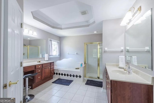 bathroom featuring tile patterned flooring, a raised ceiling, plus walk in shower, and vanity