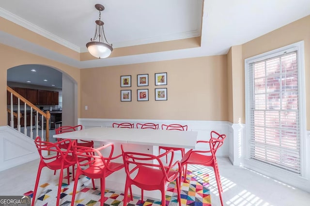 dining room featuring a tray ceiling and ornamental molding