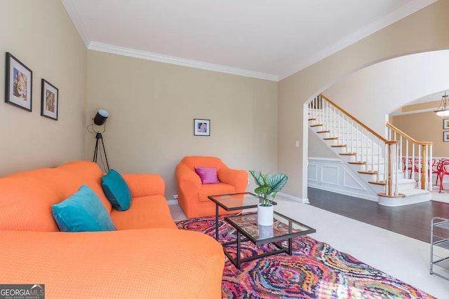 living room with ornamental molding and hardwood / wood-style floors