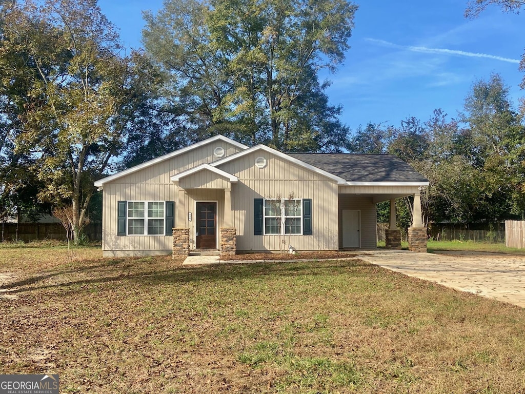 view of front of property with a front yard and a carport