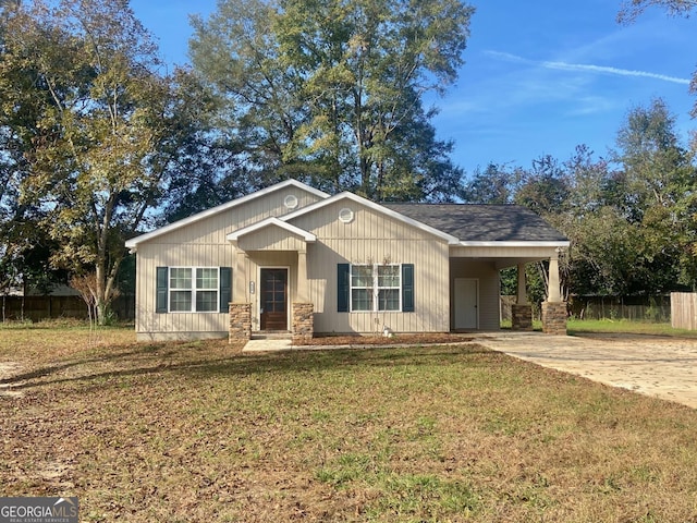 view of front of property with a front yard and a carport