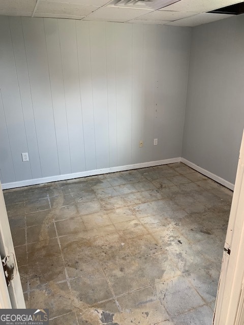 unfurnished room with a paneled ceiling