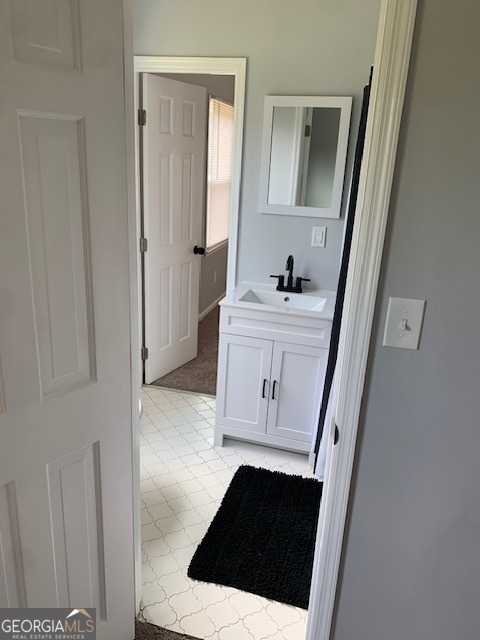 bathroom with tile patterned floors and vanity