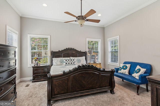 carpeted bedroom with ceiling fan and ornamental molding