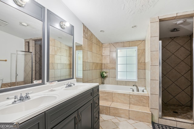 bathroom featuring dual vanity, shower with separate bathtub, tile patterned floors, and tile walls