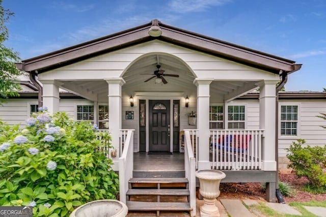 property entrance with ceiling fan and a porch