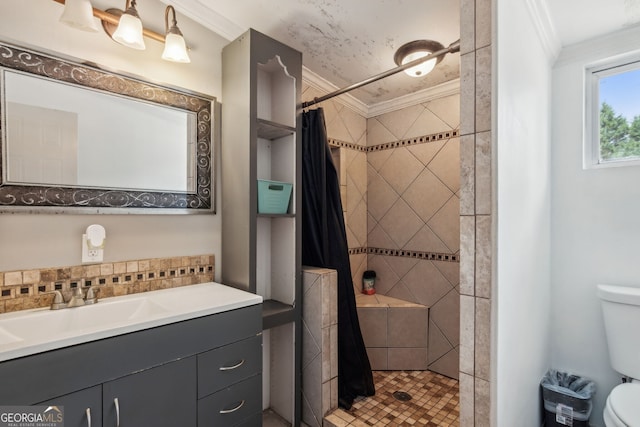 bathroom featuring toilet, a shower with shower curtain, crown molding, and vanity