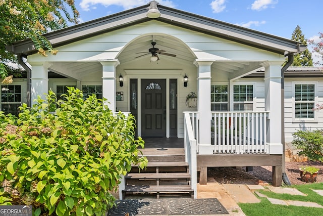 doorway to property with ceiling fan and a porch