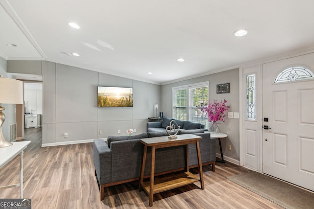 living room featuring crown molding, wood-type flooring, and lofted ceiling