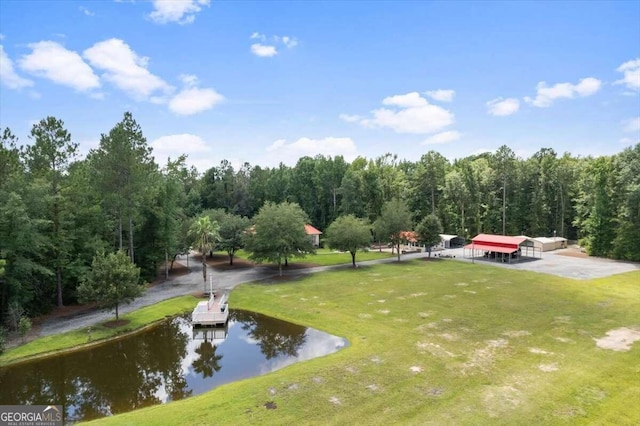 view of home's community featuring a water view and a yard