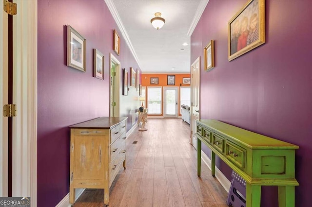 hall featuring ornamental molding and light wood-type flooring