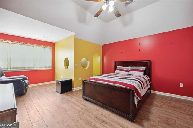 bedroom with ceiling fan and hardwood / wood-style flooring